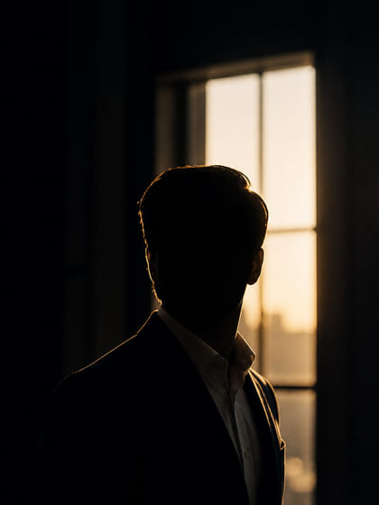 A backlit portrait of the founder, deliberately kept in shadow.